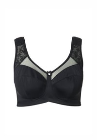 Reggiseno nero con pannelli in tulle trasparente e dettagli in pizzo. Presenta un design strutturato, spalline larghe e un fiocco decorativo frontale.