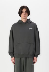 Dark gray oversized hoodie made of cotton blend, featuring a front pocket and ribbed cuffs, with "lowlights" logo in white on the chest.