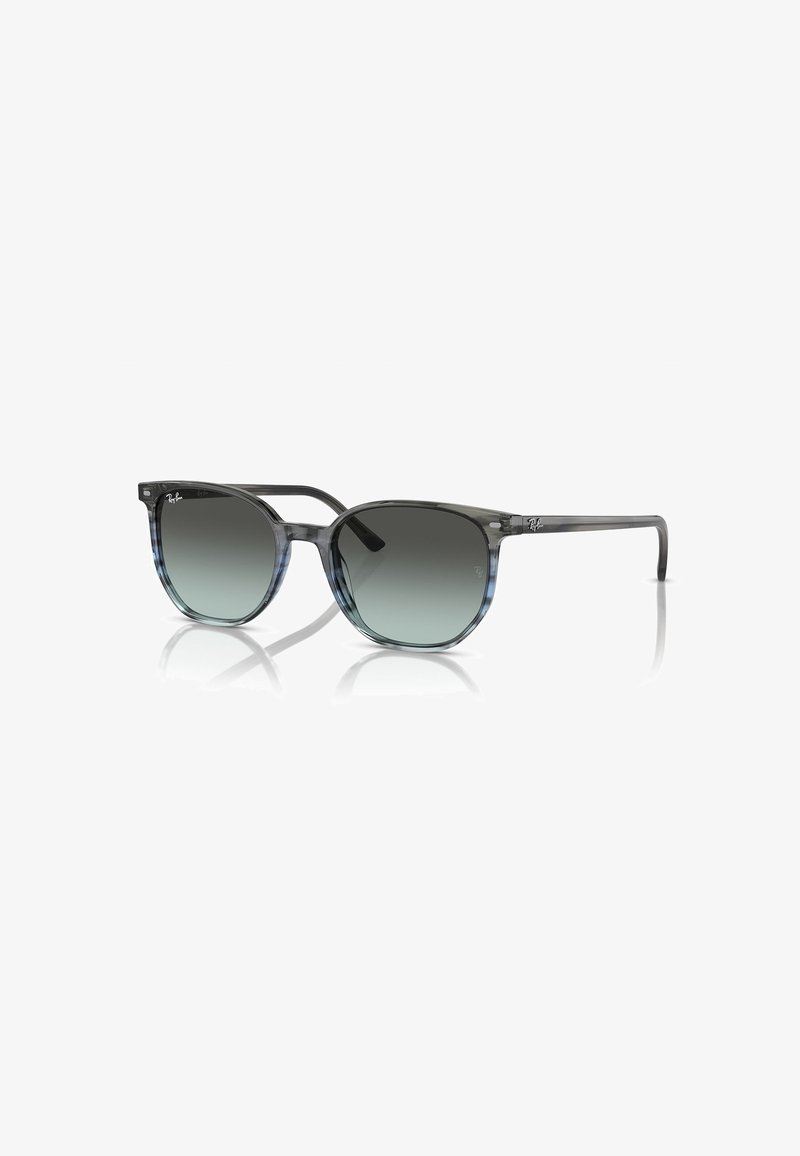 Occhiali da sole con gradiente grigio e blu, forma della lente rotonda, montatura trasparente e logo Ray-Ban discreto sui lati.