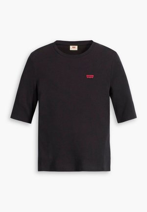 Crna pamučna majica s okruglim izrezom i kratkim rukavima. Ima mali crveni Levi's logo na prsima. Mekan na dodir.