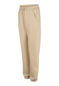 Beiga mjukisbyxor av mjukt tyg med resår i midjan och dragsko, sidfickor och elastiska muddar vid anklarna.