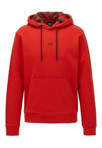 Haut à capuche rouge avec une doublure de capuche foncée à motifs, cordons de serrage réglables et une poche avant. Présente un petit logo sur la poitrine.