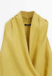 Sleeveless yellow linen dress with wide collar and overlapping front placket, labeled Massimo Dutti, made in China.