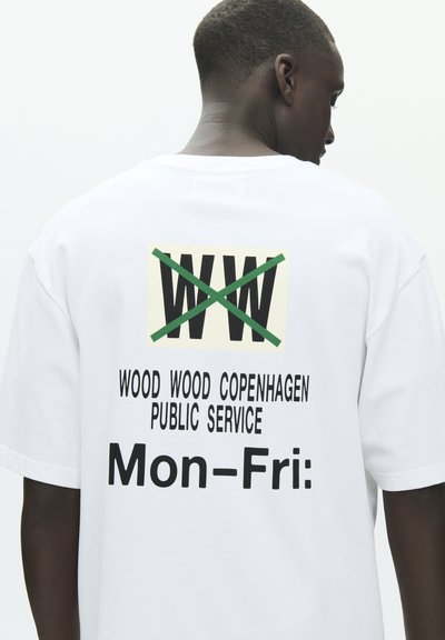 Hvit bomulls-T-skjorte med et grafisk trykk på baksiden med "WW" krysset ut, "WOOD WOOD COPENHAGEN" og "Man-Fre:" i fet svart tekst.