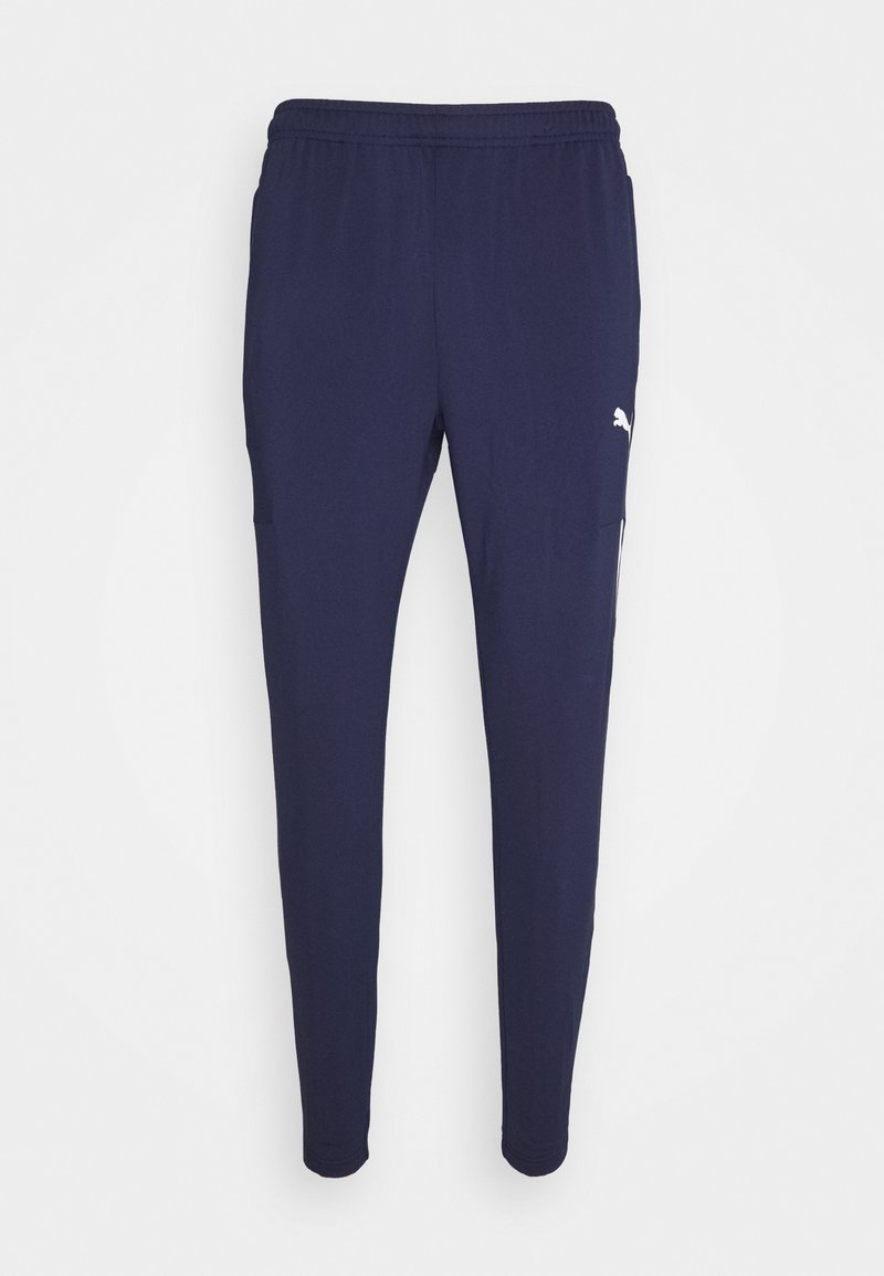 Jogging en marine fabriqués en tissu léger et extensible, avec une taille élastique, des poches latérales et un petit logo blanc.
