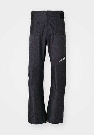 Pantaloni neri a fantasia con un design elegante, caratterizzati da una sottile texture geometrica e una vita regolabile. Logo visibile sul lato.