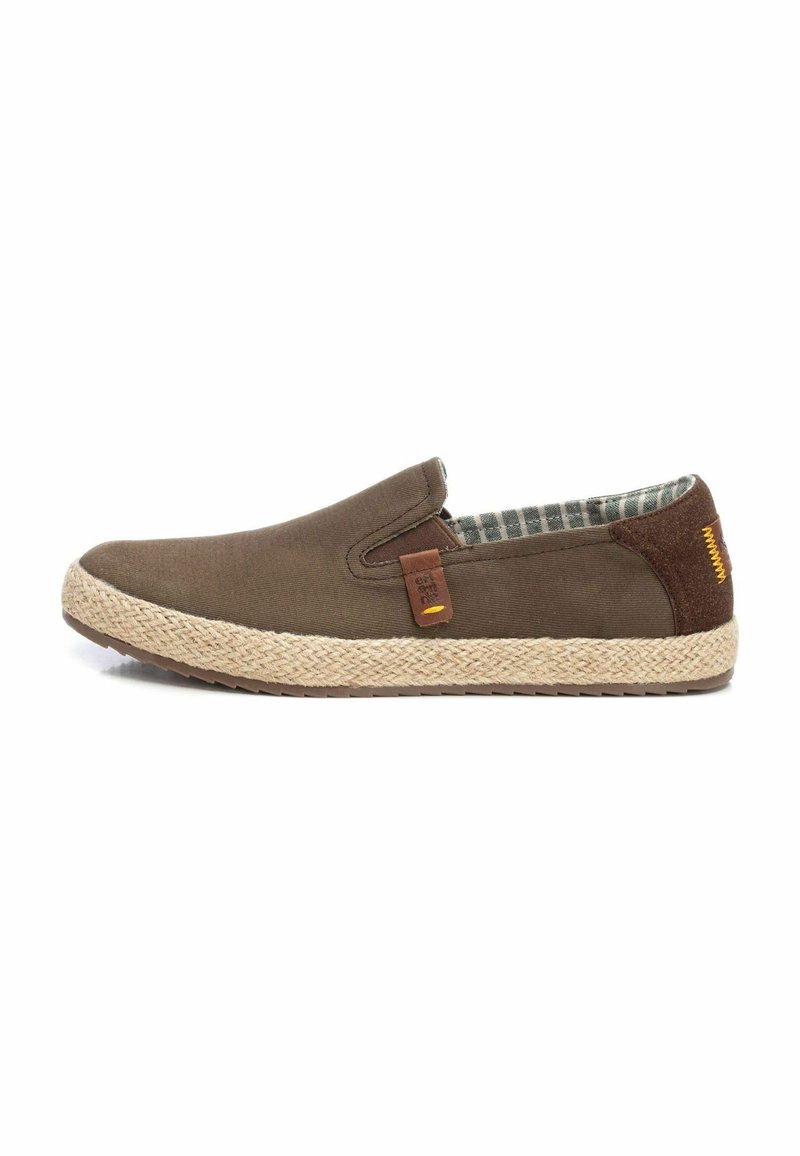 Zapatos de lona marrones sin cordones con suelas de yute tejidas, que cuentan con un forro de tela a cuadros y una pequeña etiqueta de cuero en el lado.