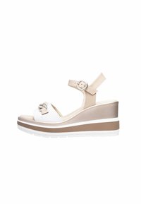 Wedge sandal featuring a white front strap with decorative bow, beige ankle strap, and a layered wedge sole in beige and white.