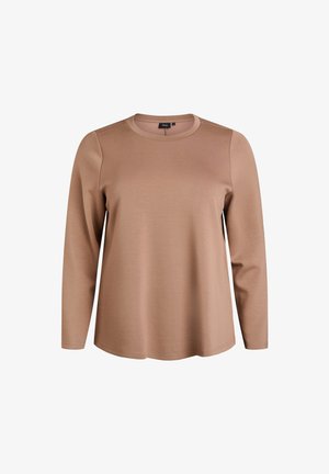 Pikem varrukaga särk pehmest, heledast pruunist kangast. Omab ümmargust kaelust ja lõdvestunud istuvust, millel on õmblusdetailid varrukatel.