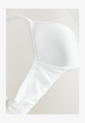 Balts krūšturis ar gludu audumu, veidotiem kausiem, plānām regulējamām siksniņām un bezšuvēm malām, nodrošinot tīru dizainu.