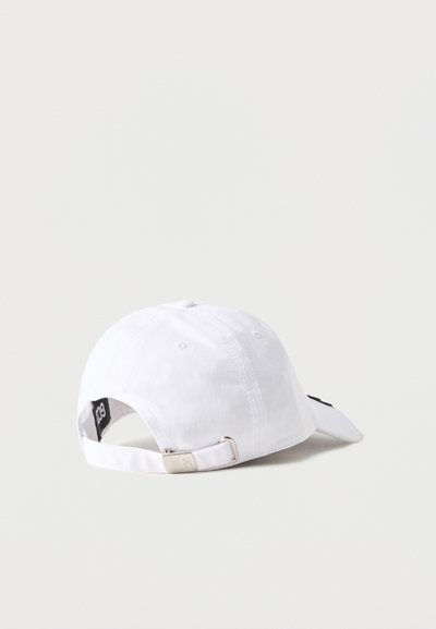 Λευκό βαμβακερό καπέλο του μπέιζμπολ με ρυθμιζόμενο μεταλλικό λουράκι, εμφανίζεται από πίσω σε ένα απλό φωτεινό φόντο.