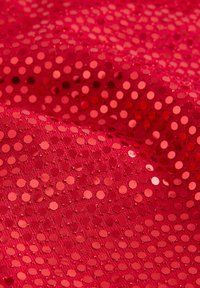 Punainen paljettil fabric, jossa on teksturoitu tausta ja suuret, kiiltävät pyöreät paljetit, jotka ovat tasaisesti jaettu koko pinnalle lisäämään kimallusta.