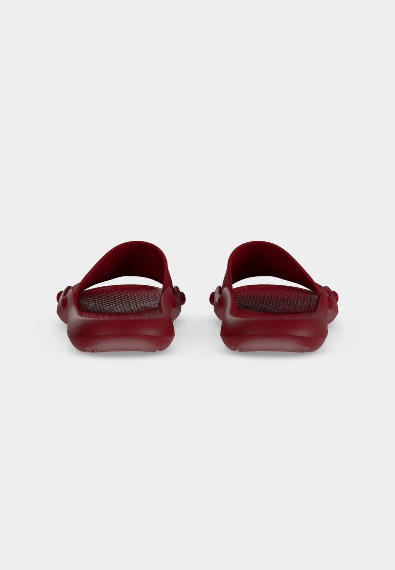 Pair of dark red open-back slide sandals with textured footbeds, viewed from the rear on a plain gray background.