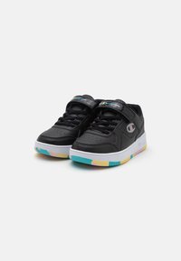 Black synthetic sneakers with a white midsole and multicolored rubber outsole. Features include lace-up closure and a stitched logo on the strap.