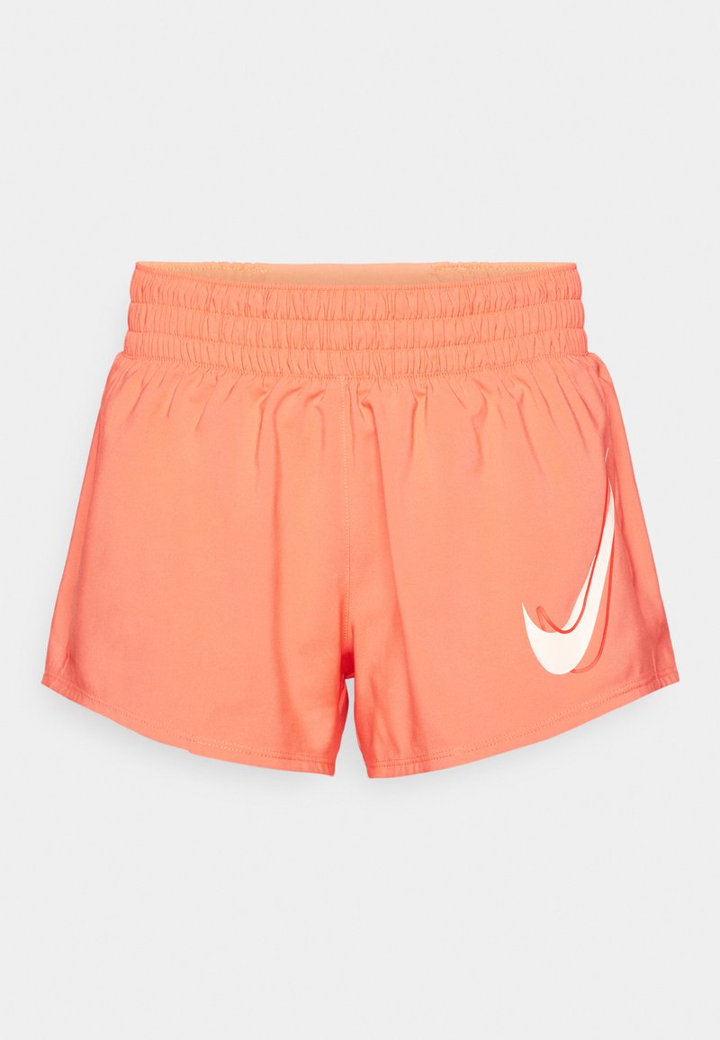 Pantalones cortos deportivos color coral con cintura elástica, textura suave y un destacado logotipo blanco de Nike en el lado izquierdo frontal.