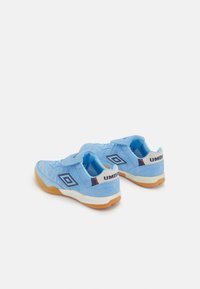 Blue athletic shoes with a soft suede upper, designed with a velcro strap and gum rubber outsole, featuring a logo on the heel and tongue.