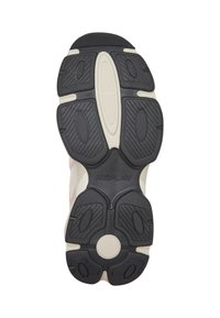 Semelle d'une basket avec des motifs noirs et blancs, avec le mot "REPLAY" embossé au centre.