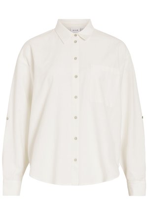 Λευκό πουκάμισο με μακριά μανίκια με κουμπιά, γιακά και τσέπη στο στήθος, με λουράκια για να γυρίζουν τα μανίκια.