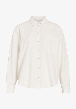 Λευκό πουκάμισο με μακριά μανίκια με κουμπιά, γιακά και τσέπη στο στήθος, με λουράκια για να γυρίζουν τα μανίκια.