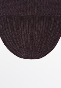 Tappeto rotondo lavorato a maglia in un profondo bordeaux, caratterizzato da una texture a coste e un bordo liscio, adatto per uso interno.