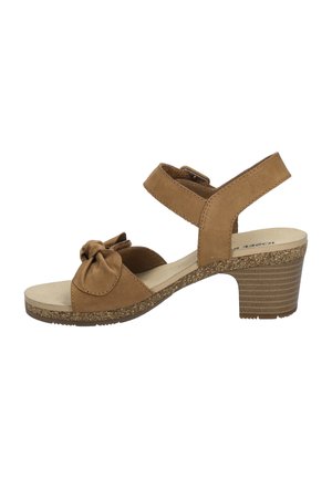 Brown suede sandal with a bow accent, adjustable ankle strap, and a textured cork-style heel. Open toe design and cushioned footbed.