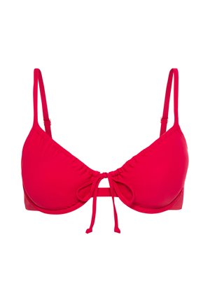 Red bikini top with adjustable straps, soft gathered fabric, and central tie detail. Smooth texture and triangular cup shape.