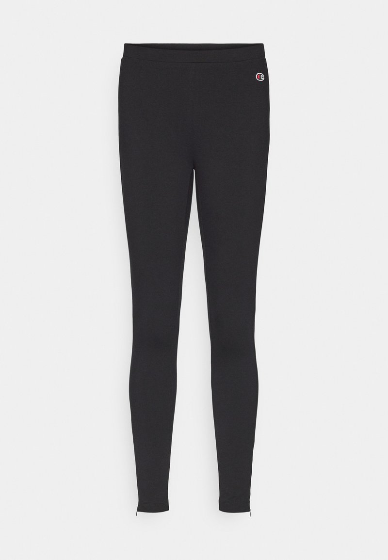 Leggings neri slim-fit con piccolo logo Champion sulla coscia sinistra e cerniere alle caviglie su sfondo bianco.