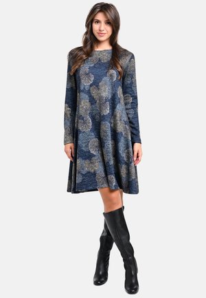 Blue dress with a floral pattern in gray and beige, long sleeves, flared skirt, paired with knee-high black boots. Soft fabric texture.