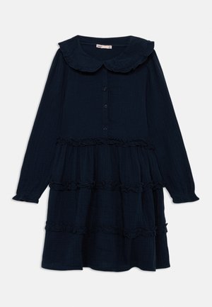 Navy blue, long-sleeve dress with a ruffled collar and tiered design. Features button closure and textured fabric.