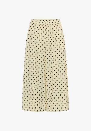 Világosbarna, bőszárú nadrág fekete pöttyökkel, rugalmas derékrésszel és laza, légies szabással.