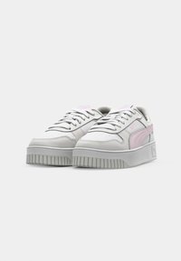 White and light gray sneakers with a pink accent, featuring a smooth leather upper, lace-up design, and textured rubber sole.
