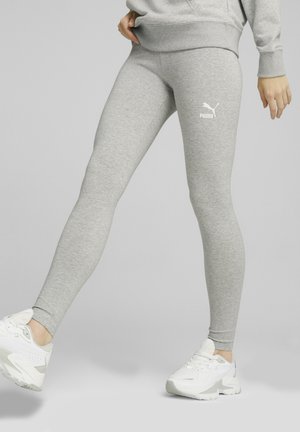 Gray athletic leggings made of soft, stretchy fabric with a fitted design. Features a white Puma logo on the thigh. Suitable for active wear.