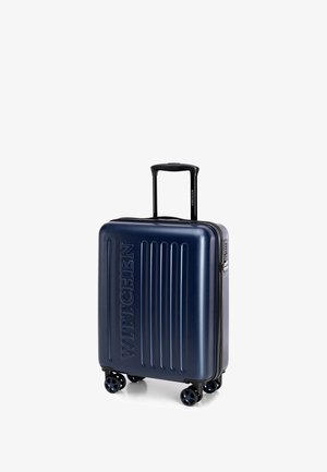 Maleta rígida de color azul marino con surcos verticales, logo grabado "WITTCHEN", mango retráctil, cuatro ruedas y cierre de cremallera.
