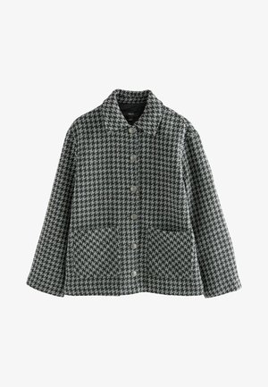 Jakke i houndstooth mønster i sort og grå, med knaplukning fortil, kraveholder, to forlommer og en afslappet pasform.