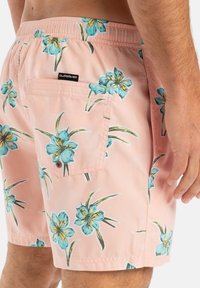 Rosa Badehosen mit floralem Muster aus blauen und gelben Blumen, elastischem Bund und einer einzigen Gesäßtasche mit Hardware-Details.