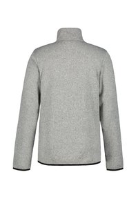 Grå ribbad fleecejacka med hög krage, långa ärmar och svart kant nertill. Har en slät yta och minimalistisch design.