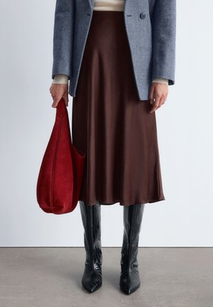 Brown satin midi skirt, grey textured blazer, red suede bag, and black embossed knee-high boots. Smooth and fitted aesthetics.