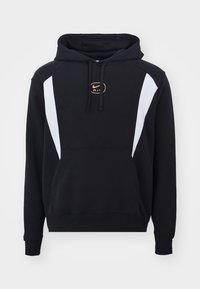 Black hoodie with white side panels and gold Nike Air logo. Features a front pocket and drawstring hood. Made from soft, textured fabric.