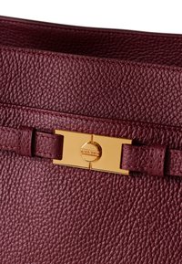 Burgundy leather handbag with a textured finish, featuring a gold-tone clasp and matching strap details.