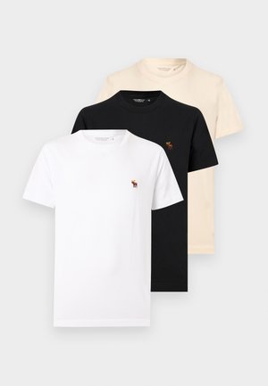 Drei schlichte T-Shirts mit Rundhalsausschnitt in Weiß, Schwarz und Beige, jeweils mit einem kleinen gestickten Elch-Logo auf der linken Brust.