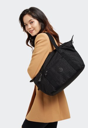 Black backpack with embossed geometric pattern, durable fabric, two zippers, and a keychain detail. Features padded shoulder straps for comfort.