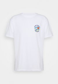 Hvid bomuld t-shirt med korte ærmer. Har et cirkulært grafisk motiv på venstre bryst, med teksten "Come Together Worldwide" og et fredssymbol.