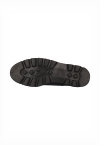 Suela de zapato negra con surcos profundos y patrones texturizados, que presenta una forma redondeada y puntos de tracción multidireccionales para un mejor agarre.