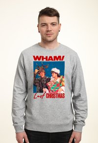 Felpa grigia con stampa colorata di due persone, con le scritte "WHAM!" e "Last Christmas" in rosso. Materiale in cotone, polsini a coste.