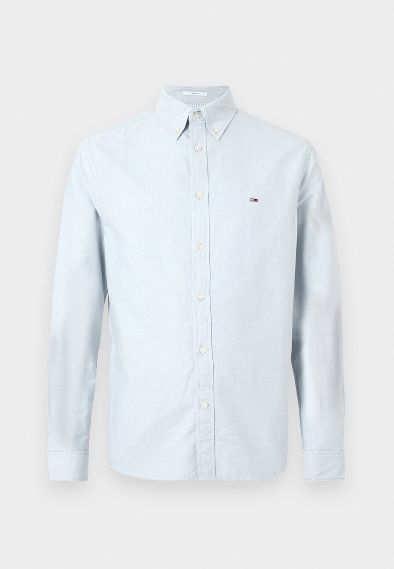 Light blue button-up shirt in soft cotton with long sleeves, point collar, and a small embroidered logo on the left chest.