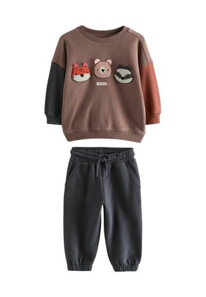 Peuteroutfit met een bruine sweatshirt met gezichten van een vos, beer en wasbeer, en zwarte joggerbroeken met koord.