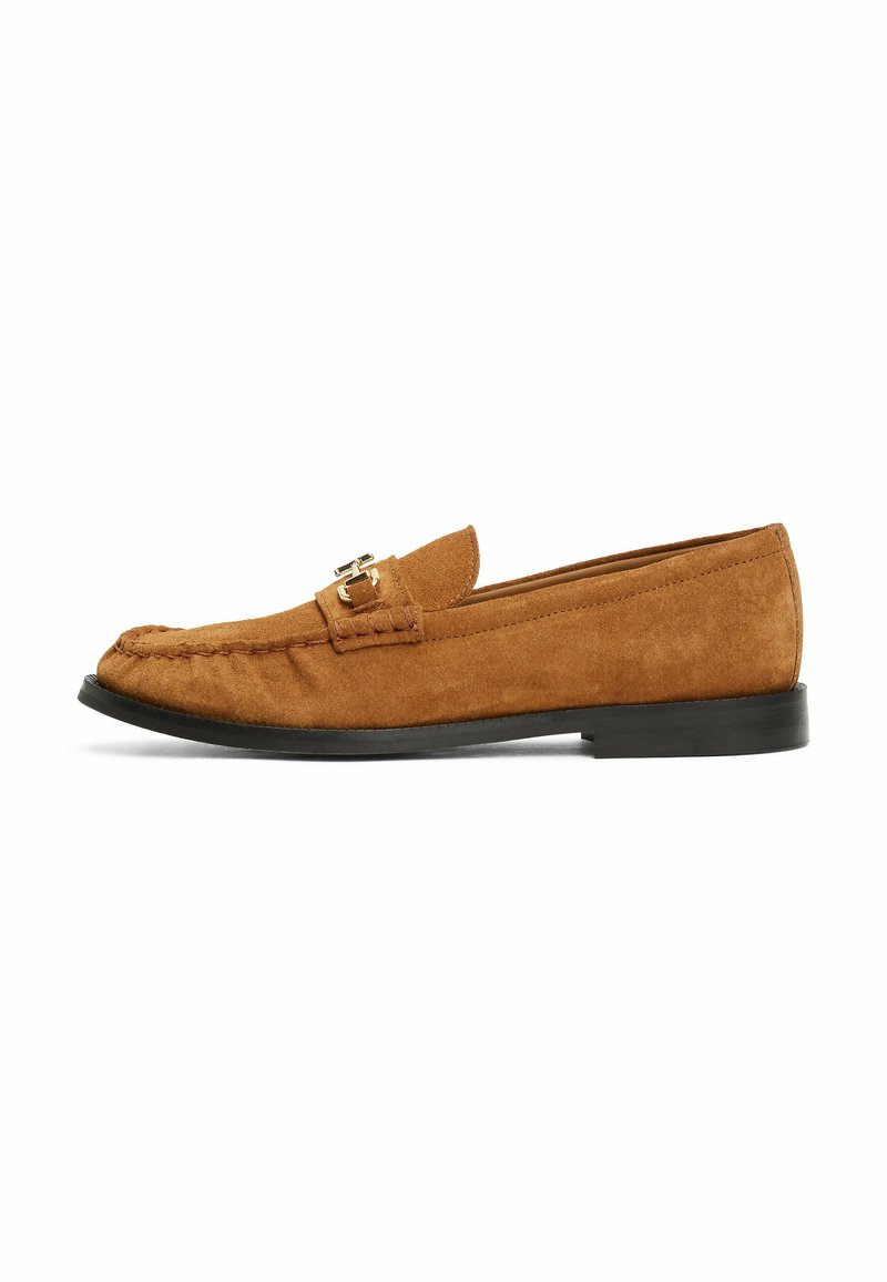 Brown suede loafers with a low black sole, featuring a decorative stitching detail and a gold-tone hardware accent on the strap.