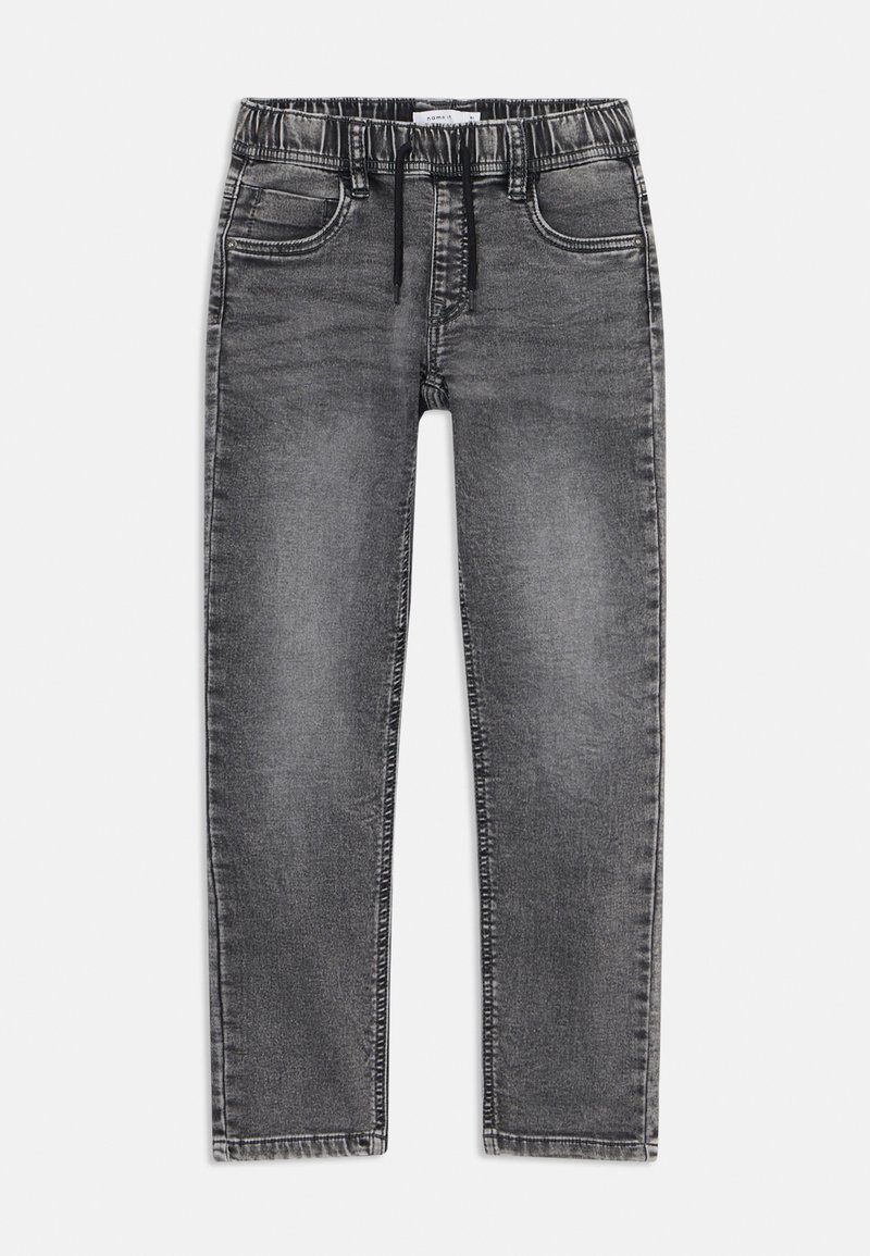 Jean en denim gris avec une taille élastique, un cordon de serrage, un design à cinq poches et une jambe fuselée. Présente une décoloration et des coutures visibles.