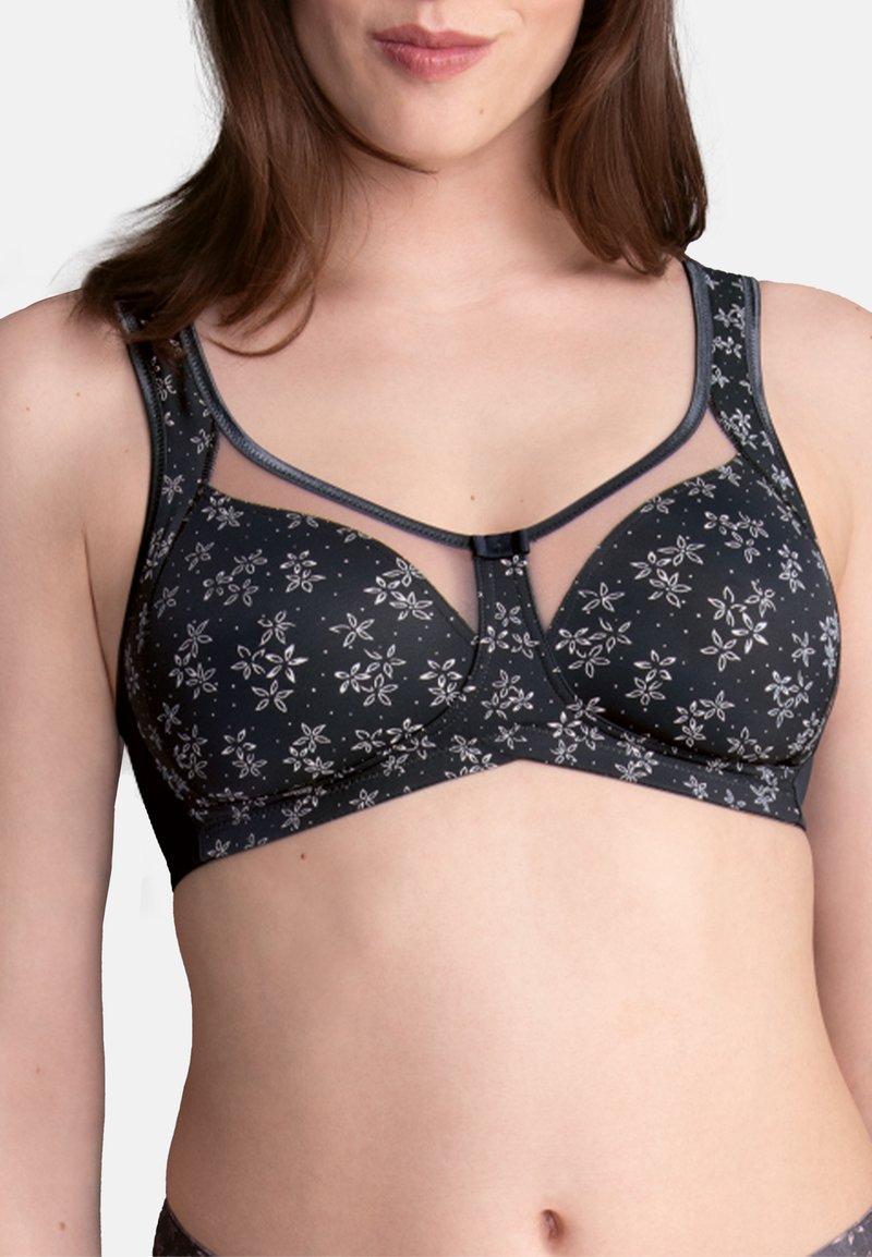 Black floral bra with sheer mesh accents and a central bow detail; features underwire and adjustable straps, providing a structured fit.