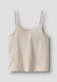 Débardeur beige à fines bretelles, fabriqué en matériau en coton doux. Présente un design simple et sans embellissements avec un ourlet droit.